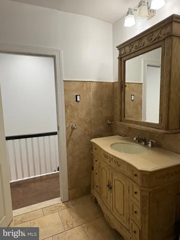 a bathroom with a sink a mirror and a vanity
