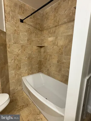 a bath tub sitting next to a toilet
