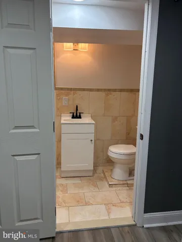 a bathroom with a toilet a sink and a window