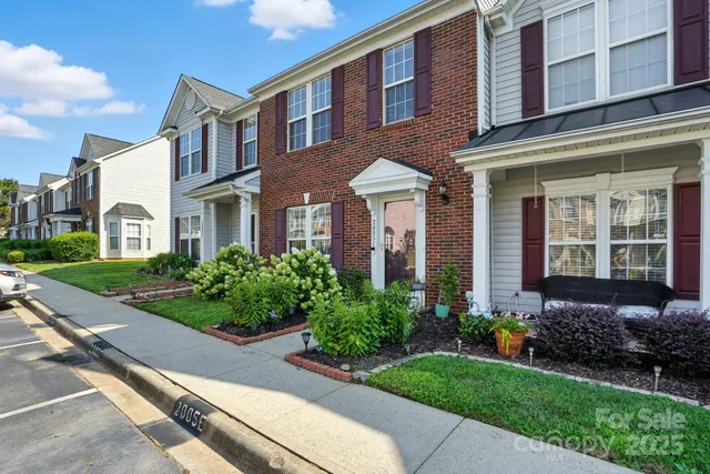 front view of a brick house with a yard