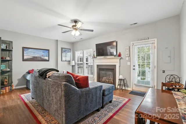 a living room with furniture fireplace and flat screen tv