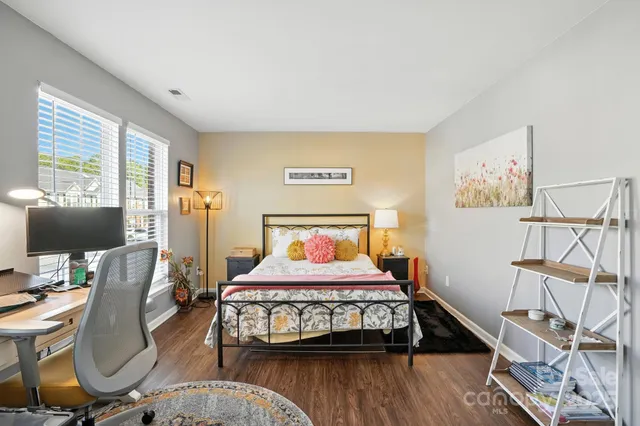 a bedroom with a bed window and a flat screen tv