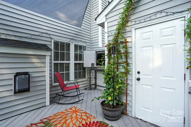 a house with potted plants in front of door