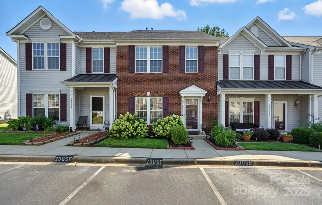 front view of a brick house with a yard