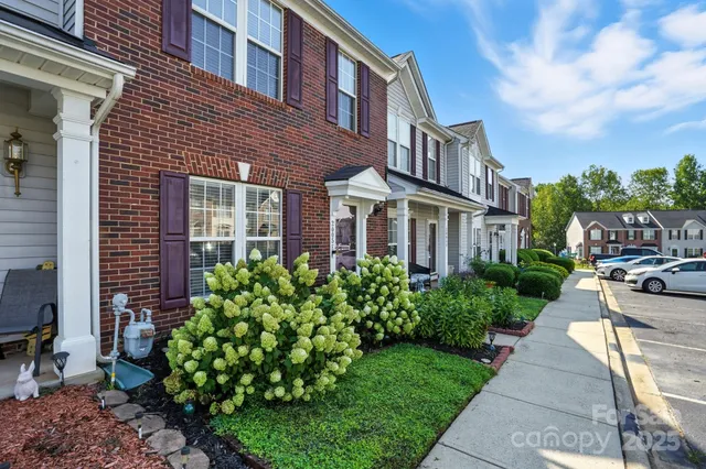 a view of a brick building next to a yard