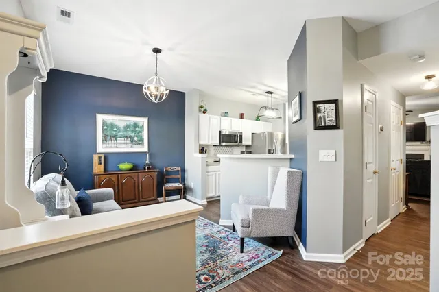 a living room with furniture and a chandelier