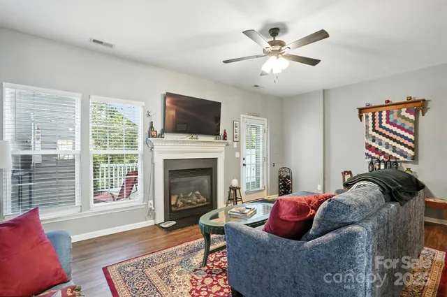 a living room with furniture fireplace and window