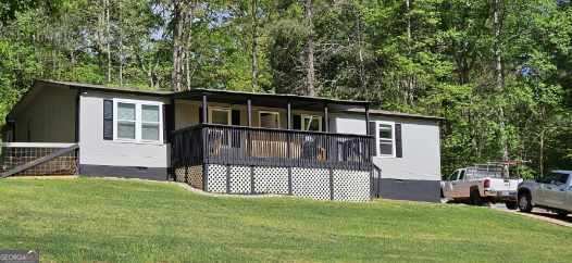 a view of a house with a yard and sitting area
