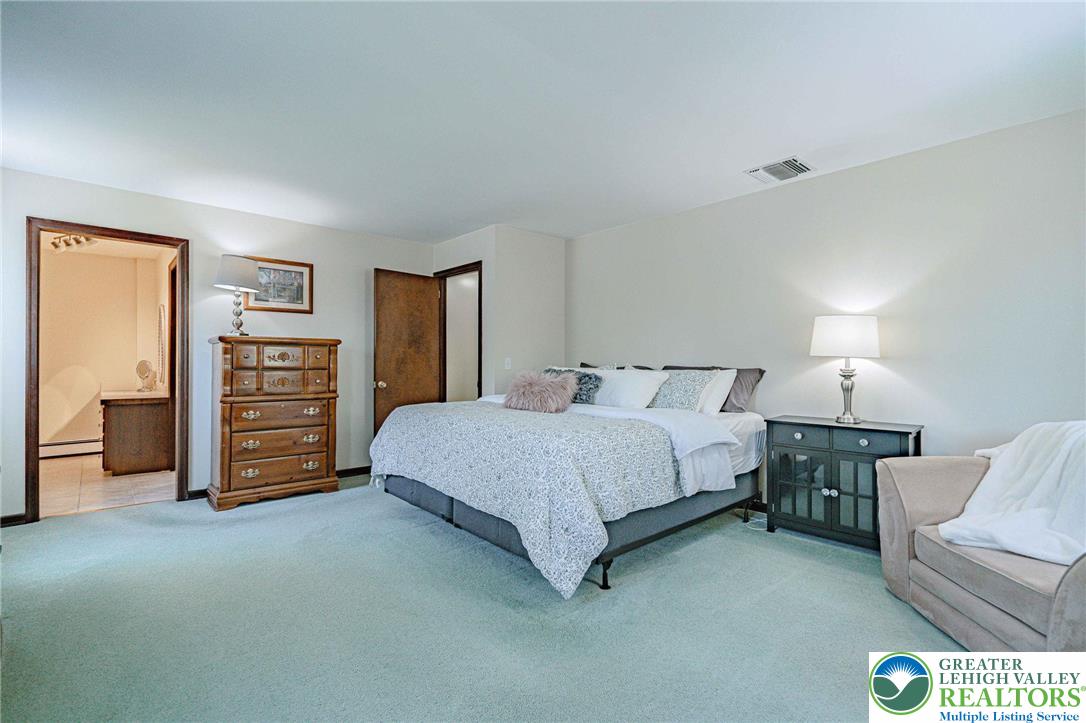 3857 Friedens Road Slatington, PA 18080 - Photo 39 of 75 This spacious room offers comfort and a private bathroom entrance, creating a serene personal retreat.