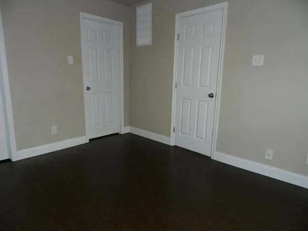 an empty room with wooden floor