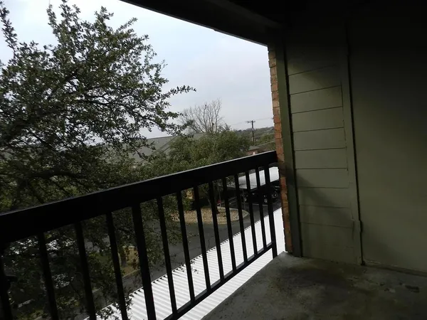 a balcony with wooden fence