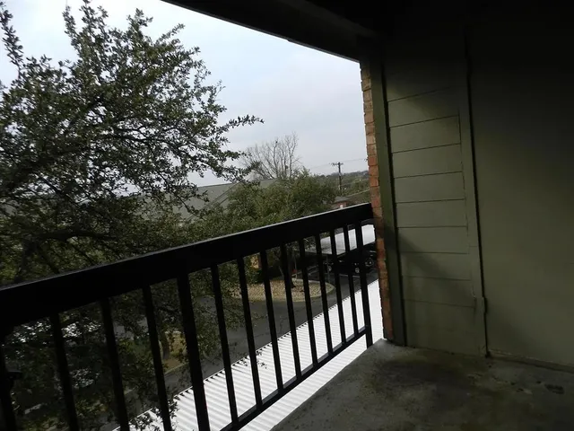 a balcony with wooden fence