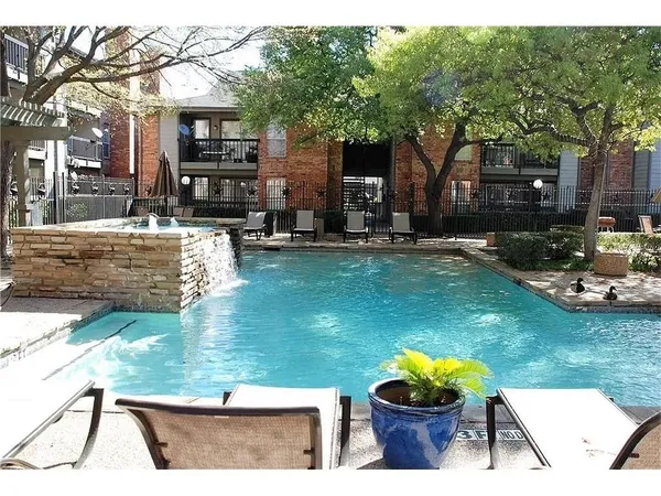 a view of a house with backyard swimming pool and sitting area