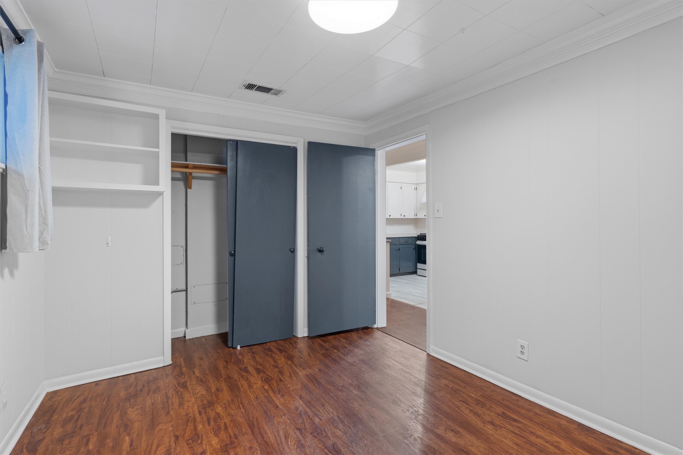 2204 Santa Rita Street Austin, TX 78702 - Photo 13 of 23 Rich wood-patterned flooring and custom built-ins define this comfortable bedroom space.
