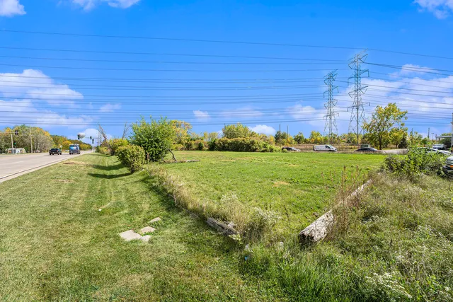 a view of a big yard with wooden fence