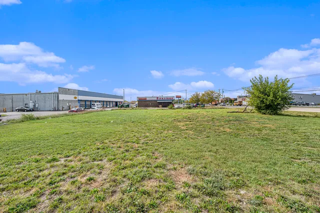 a backyard of a building with lots of green space and mountain view in back