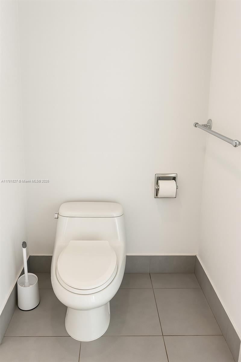 92 Southwest 3rd Street, Unit 4209 Miami, FL 33130 - Photo 11 of 31 a white toilet sitting next to a bathroom sink