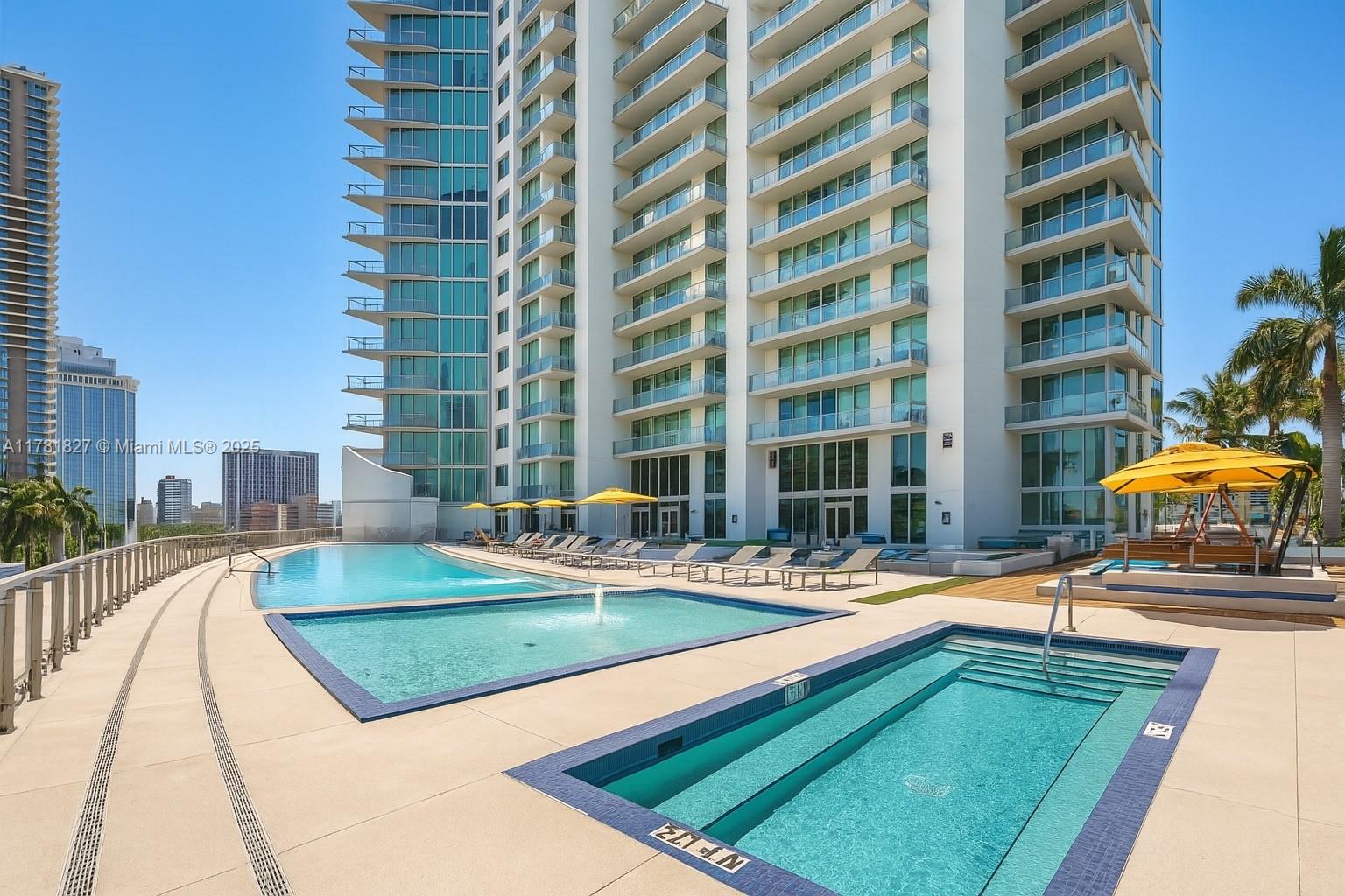 92 Southwest 3rd Street, Unit 4209 Miami, FL 33130 - Photo 14 of 31 a swimming pool with outdoor seating and yard view