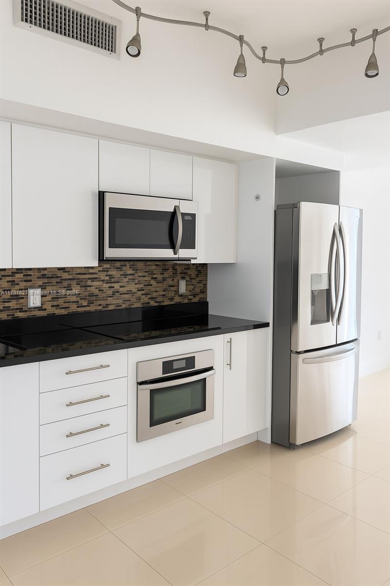 92 Southwest 3rd Street, Unit 4209 Miami, FL 33130 - Photo 2 of 31 a kitchen with stainless steel appliances granite countertop a refrigerator and a stove top oven