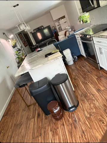 a bed room with a stove and a wooden floor