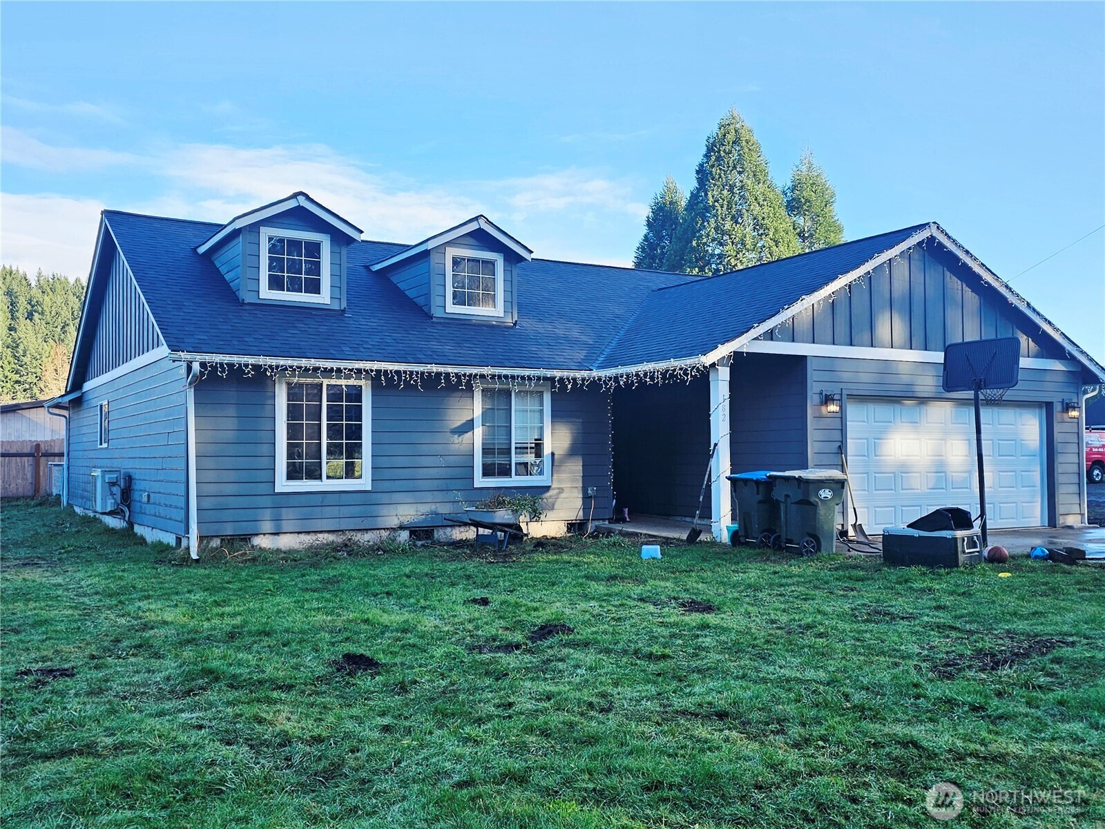 a front view of a house with a yard and fence