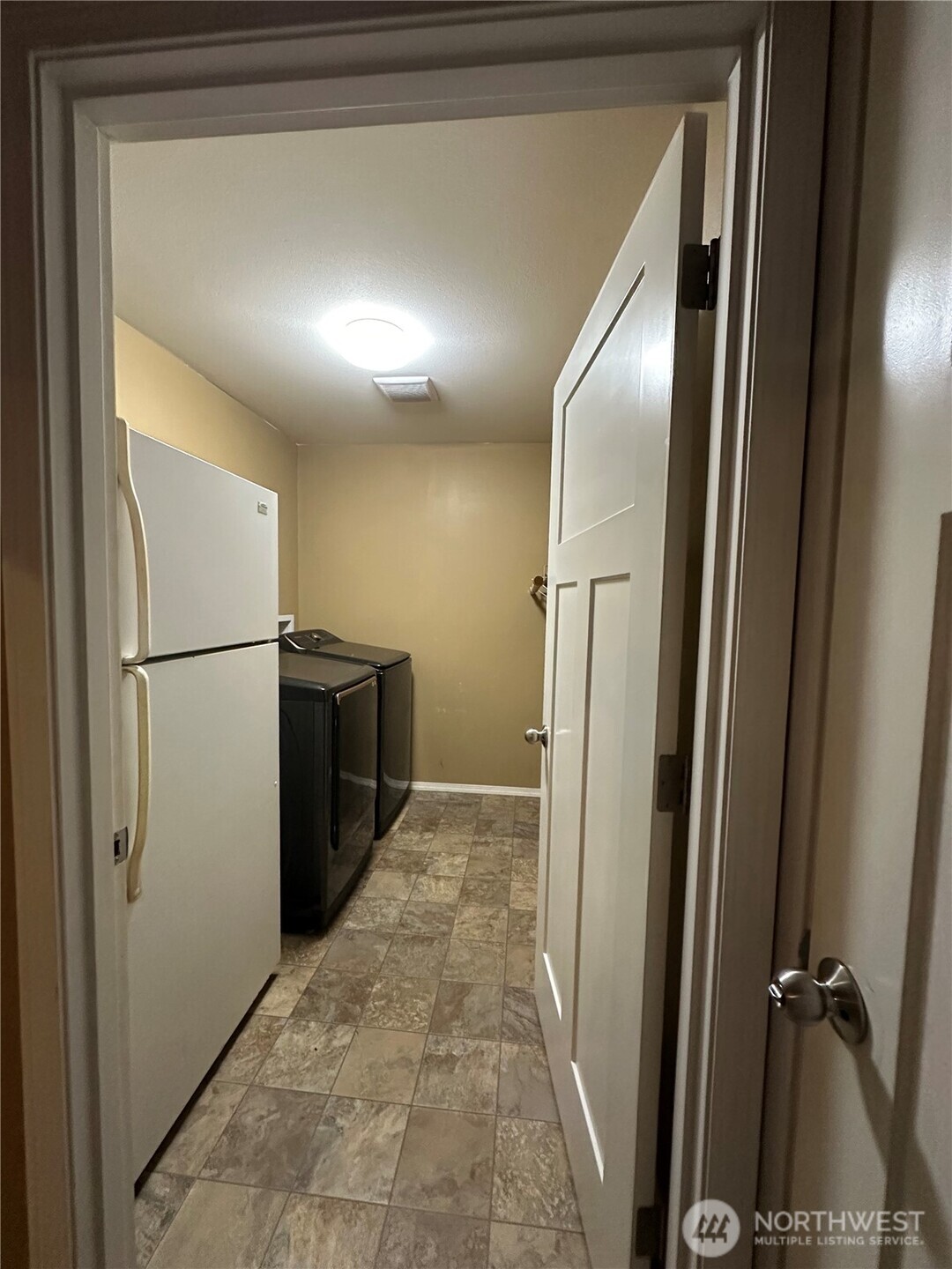 180 A Mossyrock Road West Mossyrock, WA 98564 - Photo 29 of 29 a view of a refrigerator in kitchen and an empty room with wooden floor