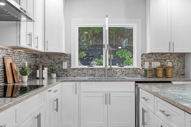 a kitchen with granite countertop a sink and a window