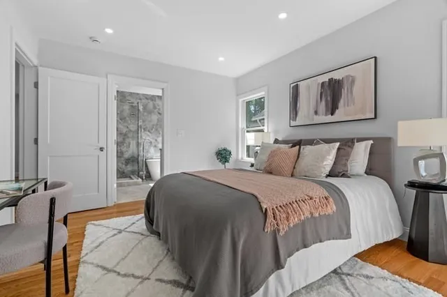 a bed room with a bed and a chair