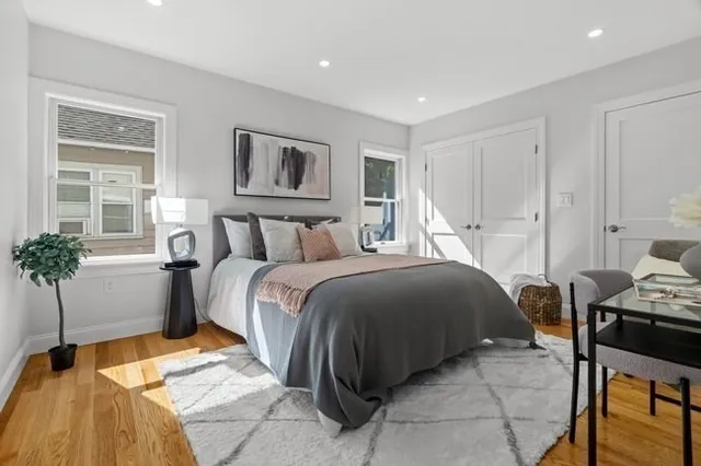 a bedroom with a bed and wooden floor