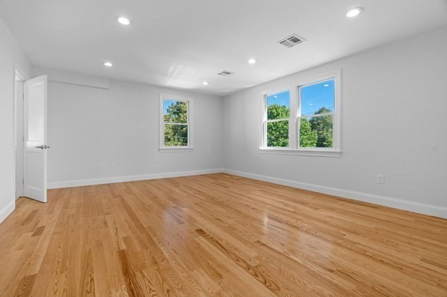 321 Albemarle Road Newton, MA 02460 - Photo 22 of 34 an empty room with wooden floor and windows