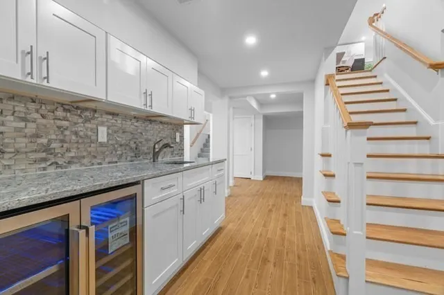 a view of a kitchen with sink and wooden floor