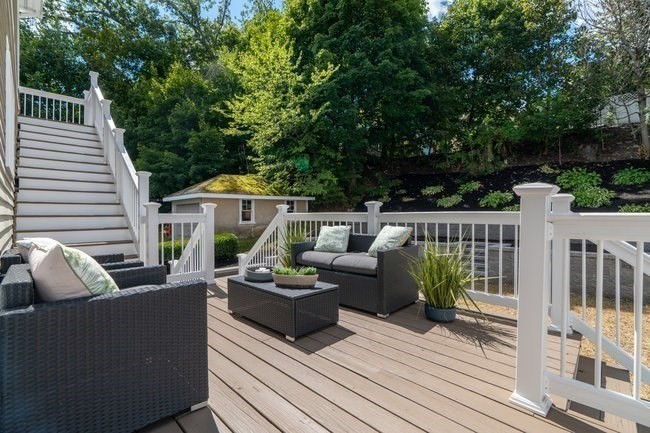 321 Albemarle Road Newton, MA 02460 - Photo 32 of 34 a view of a deck with couches table and chairs with wooden floor and fence