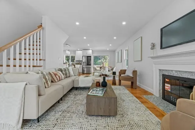 a living room with furniture fireplace and flat screen tv