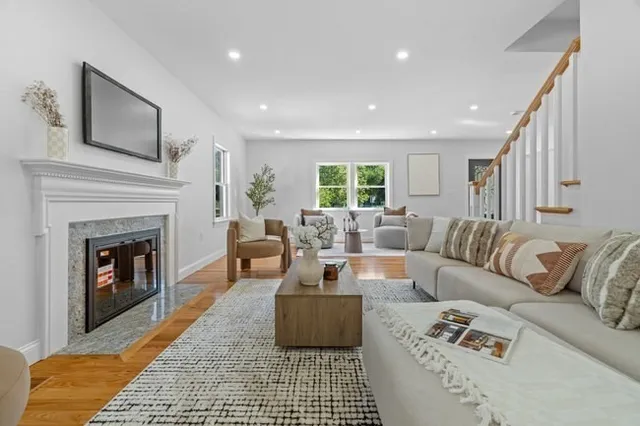 a living room with furniture and a fireplace