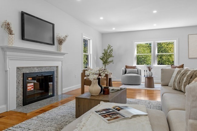 321 Albemarle Road Newton, MA 02460 - Photo 9 of 34 a living room with furniture a fireplace and a flat screen tv