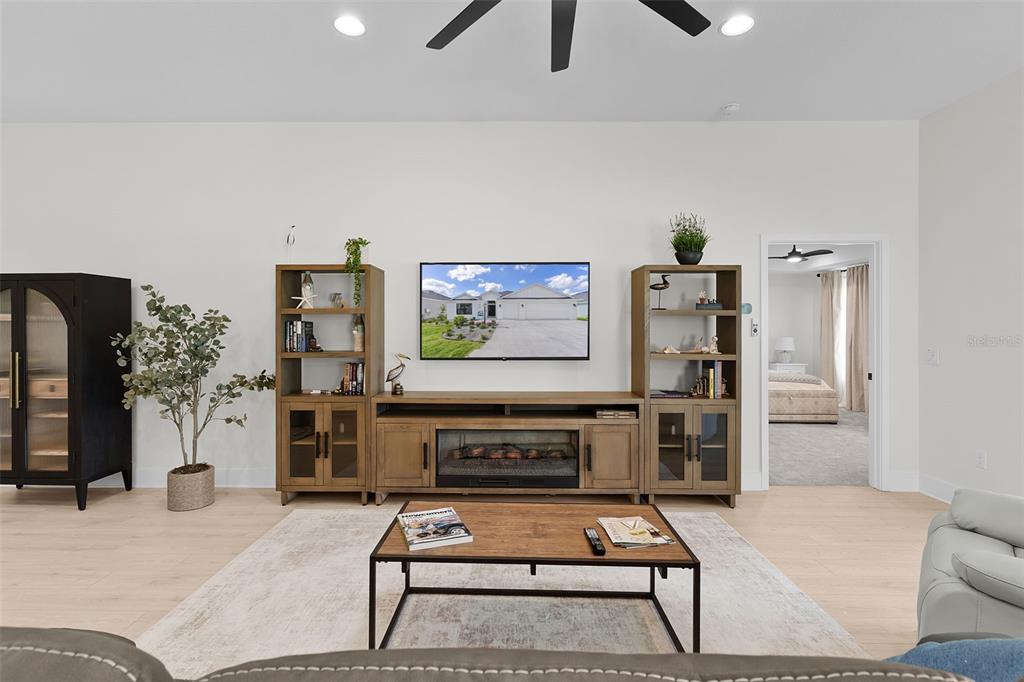 6776 Robinette Run, Unit ROBINETTE RUN The Villages, FL 34762 - Photo 11 of 52 a living room with furniture a flat screen tv and a wall