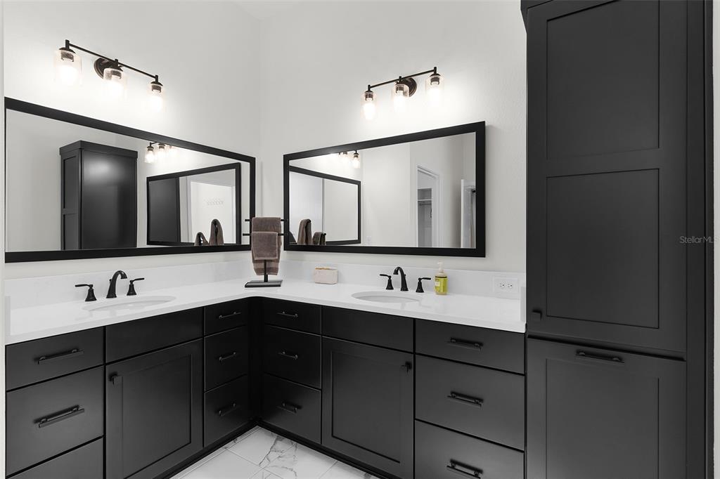 6776 Robinette Run, Unit ROBINETTE RUN The Villages, FL 34762 - Photo 20 of 52 a bathroom with a double vanity sink and mirror