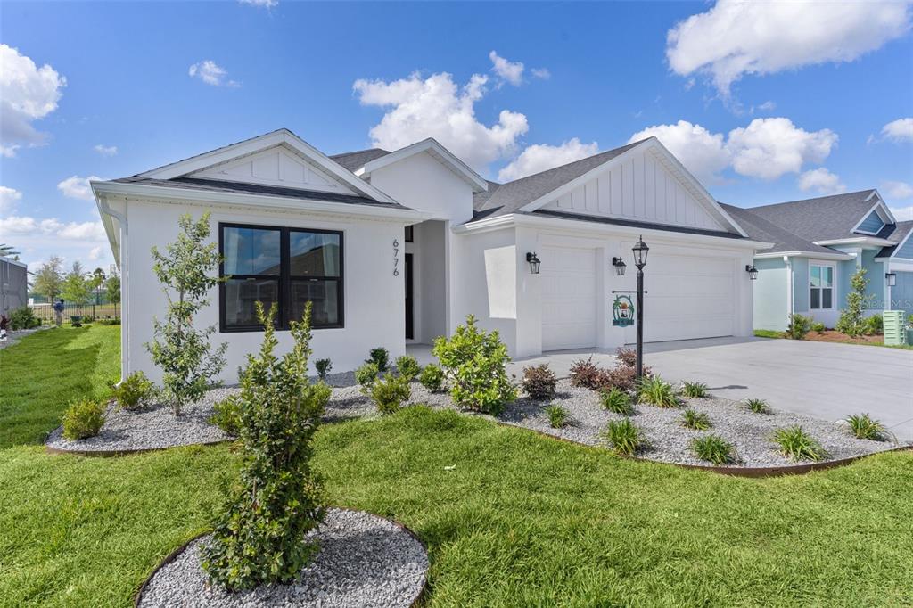6776 Robinette Run, Unit ROBINETTE RUN The Villages, FL 34762 - Photo 2 of 52 a view of a house with brick walls and a yard
