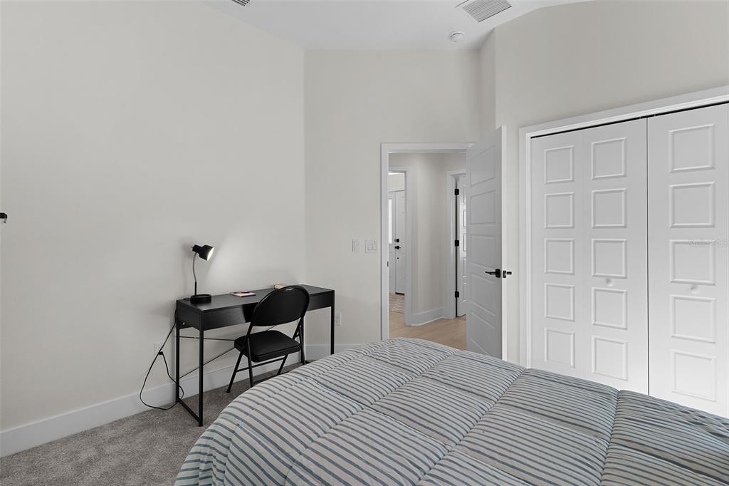 6776 Robinette Run, Unit ROBINETTE RUN The Villages, FL 34762 - Photo 28 of 52 a view of a room that has a bed and a table in it