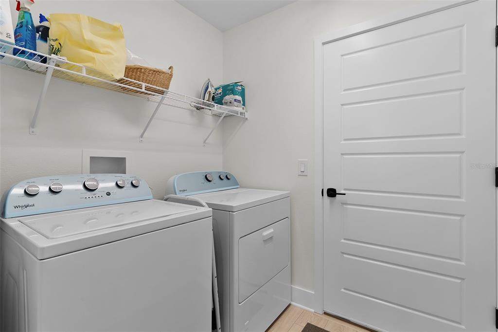 6776 Robinette Run, Unit ROBINETTE RUN The Villages, FL 34762 - Photo 29 of 52 a view of storage and utility room with washer and dryer