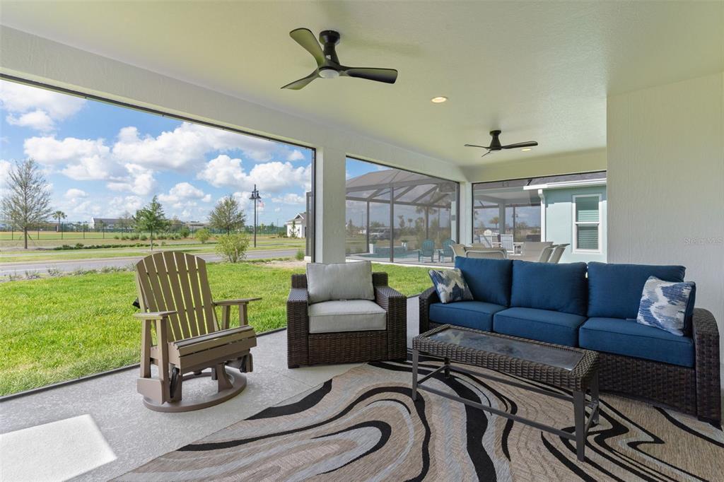 6776 Robinette Run, Unit ROBINETTE RUN The Villages, FL 34762 - Photo 38 of 52 a living room with furniture and a garden