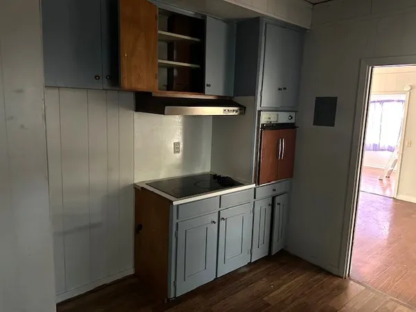 a kitchen with a stove and a refrigerator