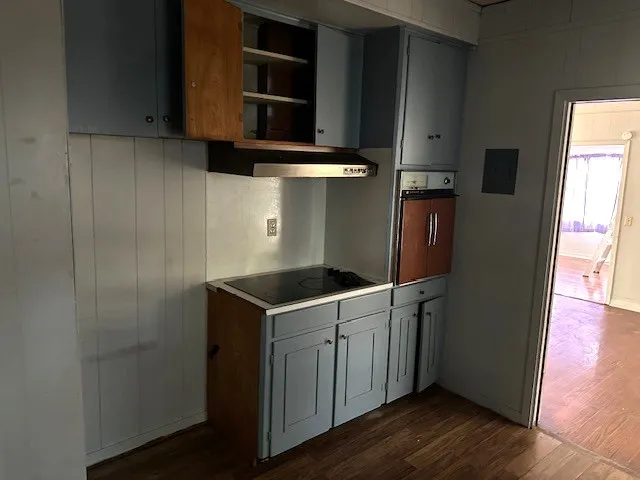 a kitchen with a stove and a refrigerator