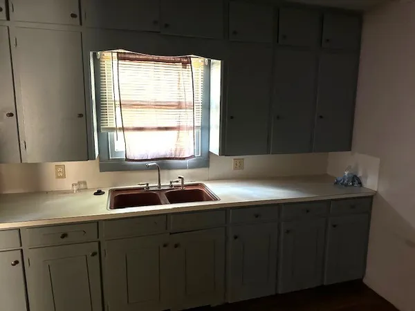 a kitchen with a sink and cabinets