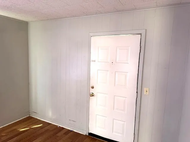 a view of front door with wooden floor