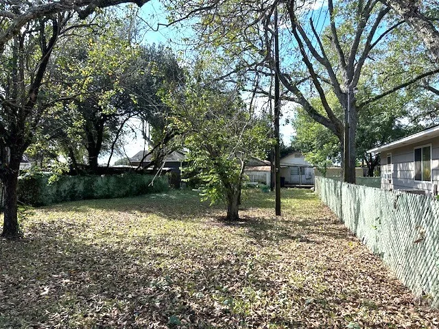 a view of a wooden house with a yard