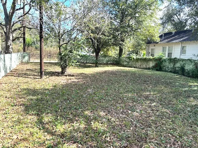 a view of a yard with trees