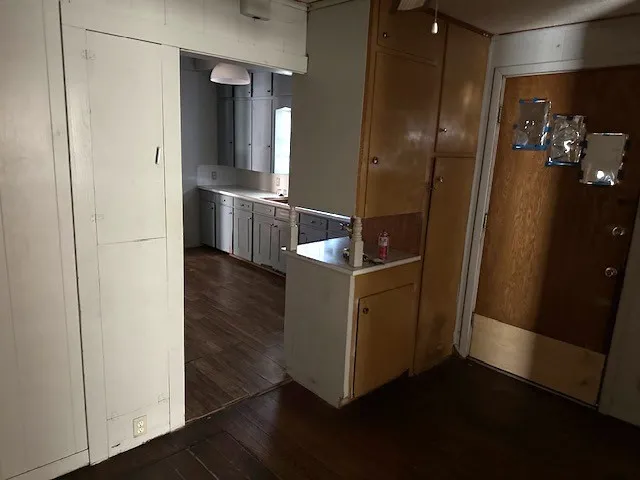 a room with wooden floor and electronic appliances