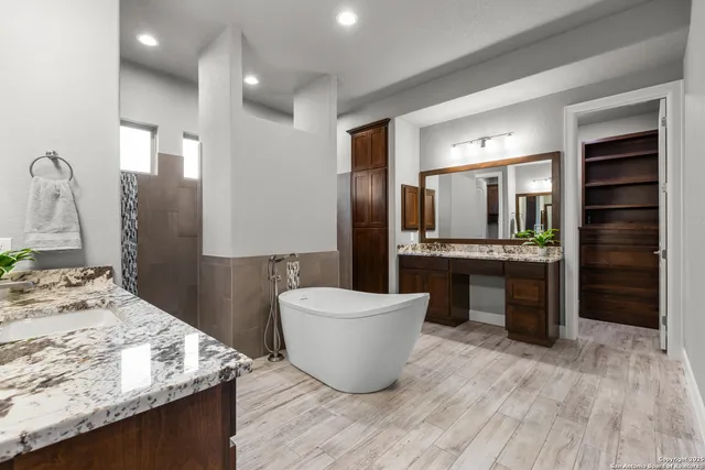 a bathroom with a sink a double vanity and a mirror