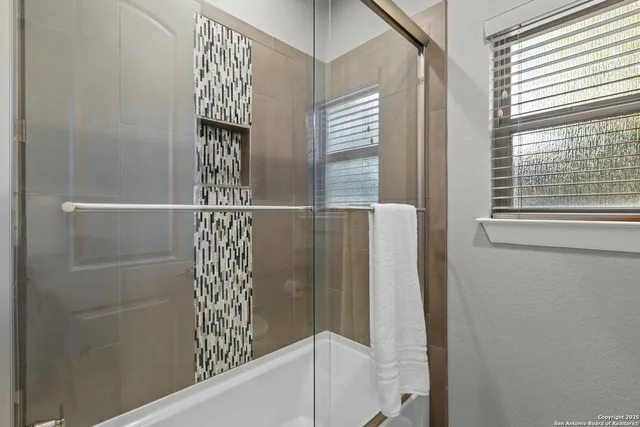 a bathroom with a bathtub and a shower